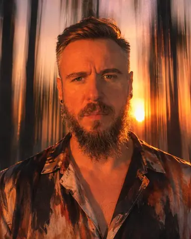 A bearded man's face frozen sharp in orange flash, palm trees smeared into vertical streaks behind him