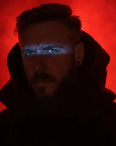 Full-length bearded man as a monumental black silhouette with wing-like shoulders against glowing red smoke