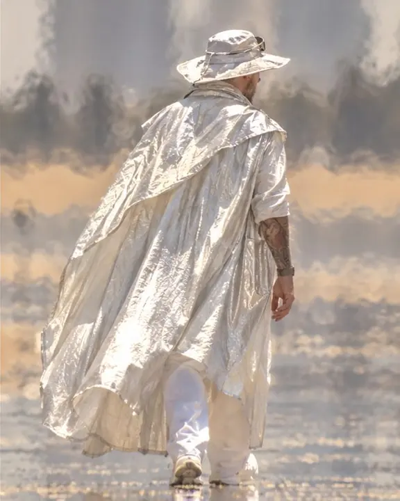 Close-up of a reflective silver coat surface flaring in harsh sun, its edges rippled by rising heat
