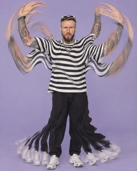 Full-length of a man raising and lowering his arms, the limbs turned into wave-shaped stripes on lilac