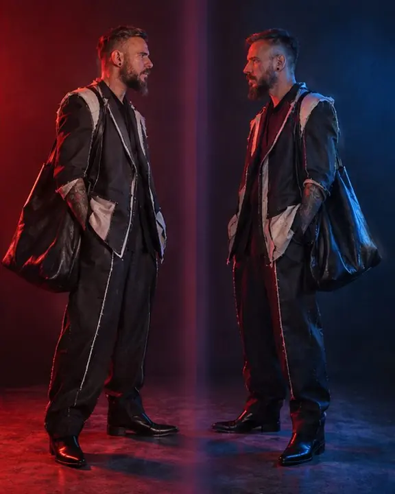 Full-length bearded man as twins, a red version on the left facing a blue version on the right across a soft seam